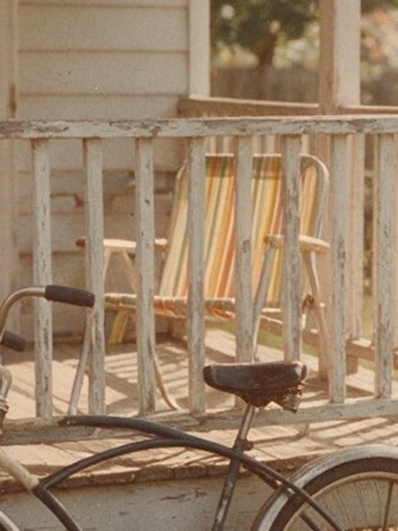 Before: soft, faded crop of a 1970s snapshot of a porch railing, striped lawn chair and bicycle, enlarged with plain bicubic resizing